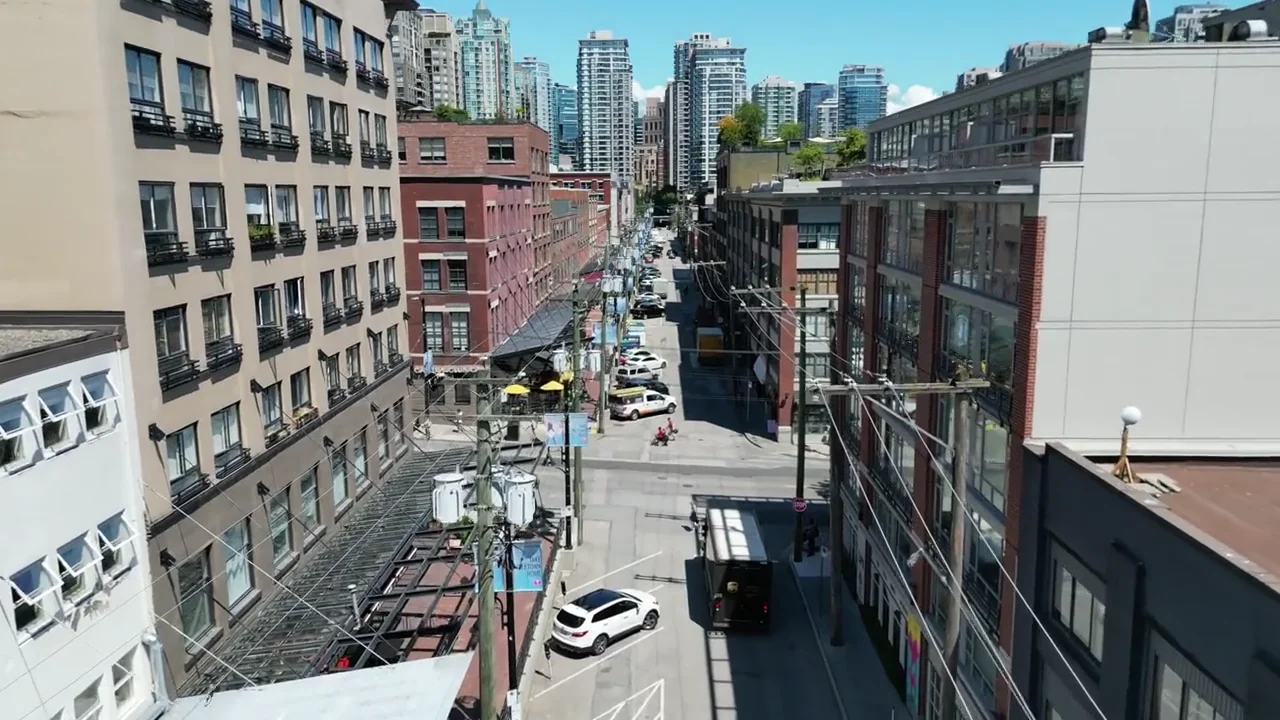 Brick warehouse streets with patios and modern towers beyond, from the supplied Yaletown film